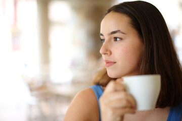 Wall Mural - Serious woman contemplating drinking coffee