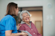 © Halfpoint - Portrait of nurse and senior patient talking in hospital corridor. Emotional support for elderly woman.