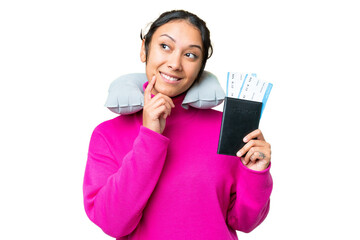 Wall Mural - Young Uruguayan woman holding a passport over isolated chroma key background thinking an idea while looking up