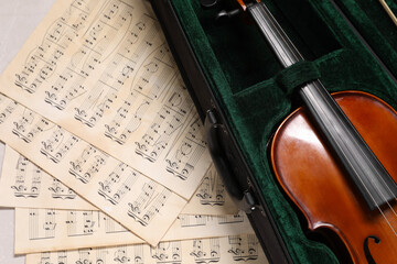 Canvas Print - Violin in case and music sheets on table, top view