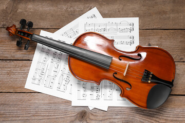 Sticker - Violin and music sheets on wooden table, top view