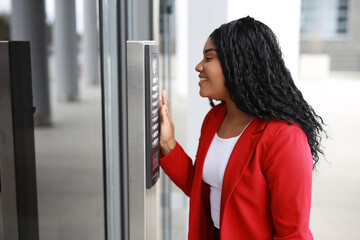 Wall Mural - young happy woman calling the intercom