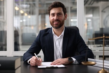 Canvas Print - Portrait of smiling lawyer at table in office