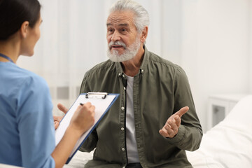 Poster - Elderly patient talking with nurse in hospital