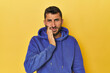 © Asier - Young Hispanic man on yellow background having a strong teeth pain, molar ache.