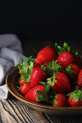 Poster - A bowl with ripe bright strawberry in rustic style