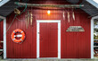 Red door of a typical rorbuer building in Lofoten