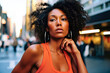 Black woman with curly hair on a cityscape