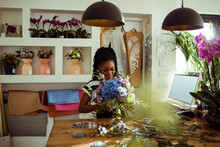 Florist Crafting A Bouquet In Her Workshop