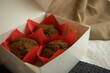 Muffins in a box on a soft background. Cupcakes. Chocolate desserts.