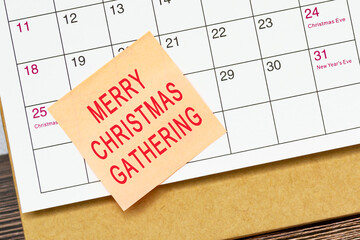 Merry Christmas Gathering words on a sticky note on a calendar background.