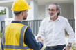 © Quality Stock Arts - Businessman project director or real estate business owner land investor happy hand shaking with engineer foreman builder in house construction site.