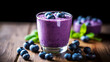 Blueberry smoothie in glass on wooden background