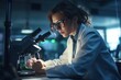 Important research. Serious experienced scientist working with her microscope and wearing a uniform and glasses. 