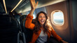 © Favio - young happy traveler woman inside an airplane, dressed in orange