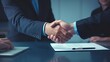 © Login - Confident handshake between people after a favorable business deal. The concept of successful negotiations, signing important documents (contract, certificate). Completion of a business transaction.