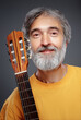 © luengo_ua - Aged bearded man with an acoustic guitar