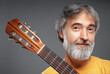 © luengo_ua - Aged bearded man with an acoustic guitar