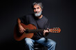 © luengo_ua - Aged bearded man with an acoustic guitar