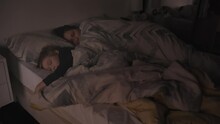 A Mom And Three Years Old Little Son Is Sleeping In The Bed