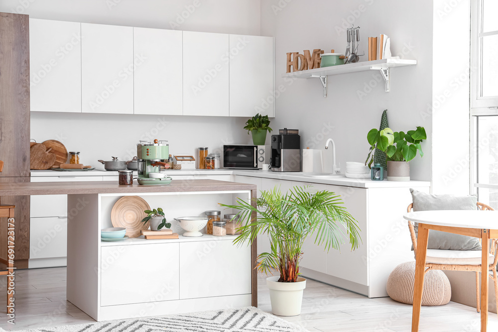 Interior of modern kitchen with coffee machine on wooden table