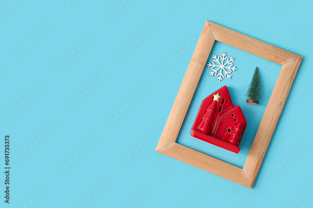 Composition with wooden picture frame and Christmas decorations on color background