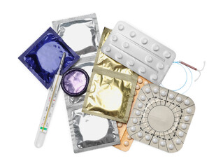 Contraceptive pills, condoms, intrauterine device and thermometer isolated on white, top view. Different birth control methods