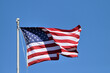 An American flag unfurls in the breeze on a flagpole at in a Chicago suburban community. The flag has long been a recognized symbol of democracy, freedom and liberty.
