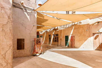 Wall Mural - Stretched fabric that provides shade from the sun on the street in reconstructed old part of the Dubai city - Al-Bastakiya quarter in the Dubai city, United Arab Emirates