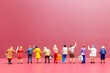 Miniature people , A group of women stand together On a pink backdrop, International Women's Day concept