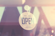 WE ARE OPEN - Open sign broad on a glass door at coffee shop (Filtered image processed vintage effect)