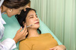 © chadchai - Doctor giving female patient medical injection in lip. Atmosphere at cosmetic surgery department in hospital clinic.