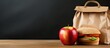 Brown paper bag with sandwich and apple for lunch. Copy space image. Place for adding text