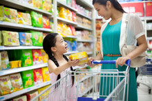 Mother And Daughter Shopping In Supermarket