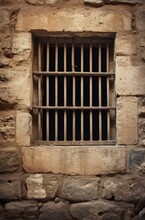 Window With Metal Bars In An Old Stone Wall