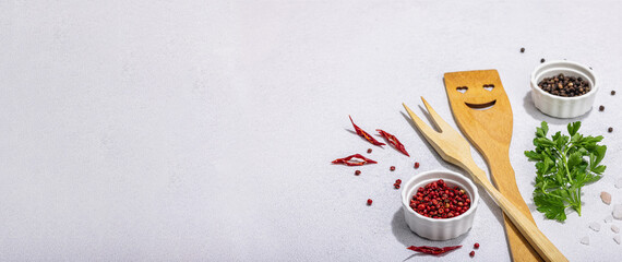 Wall Mural - Culinary background with wooden kitchen utensil, spices and herbs. Set for preparation healthy food