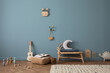 Stylish kid room with copy space, rattan bench, pouf, toys, teddy, decoration and personal accessories. Home decor.