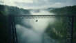 Bungee jumping sportsman jumps from a metal railway bridge over a foggy gorge.