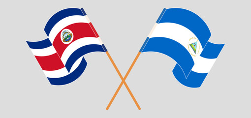 Wall Mural - Crossed and waving flags of Costa Rica and Nicaragua