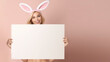 Beautiful young model holding a large blank sign with plenty of room for copy and text