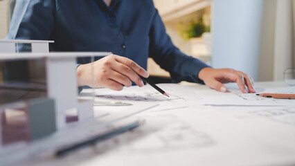 Fototapete - Architects interior designer hands working with Blue prints and documents for a home renovation for house design.