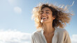 © Ari - A Blonde woman breathes calmly looking up isolated on clear blue sky