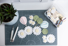 Crafting Workspace With Paper Flowers And Tools