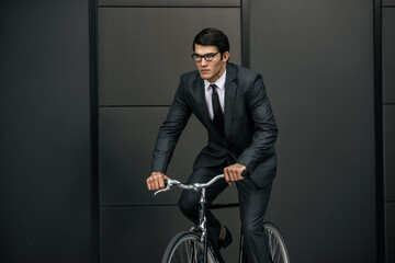 Wall Mural - Handsome young business man with his modern bicycle.