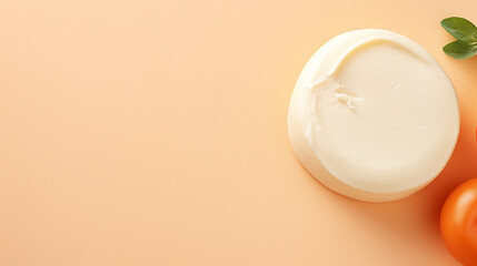 Mozzarella cheese with tomato and basil on orange background, top view