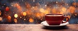 Fototapeta  - Cup of mulled cider on a table with snow falling with bokeh winter background 