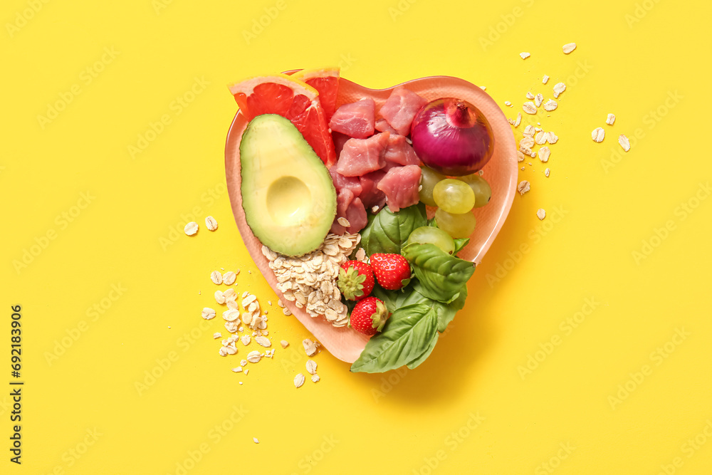 Plate with fresh healthy products on yellow background. Diet concept