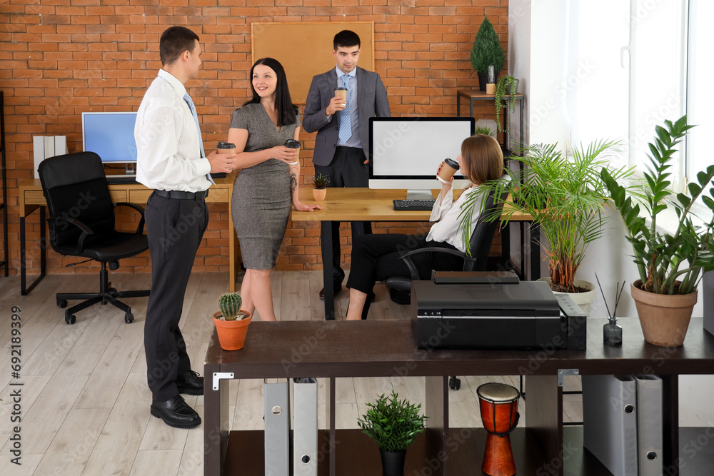 Business colleagues having coffee break in office