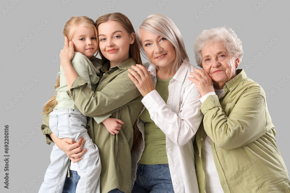 Little girl with her family hugging on light background
