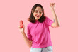 © Pixel-Shot - Young woman with block of electronic cigar on pink background